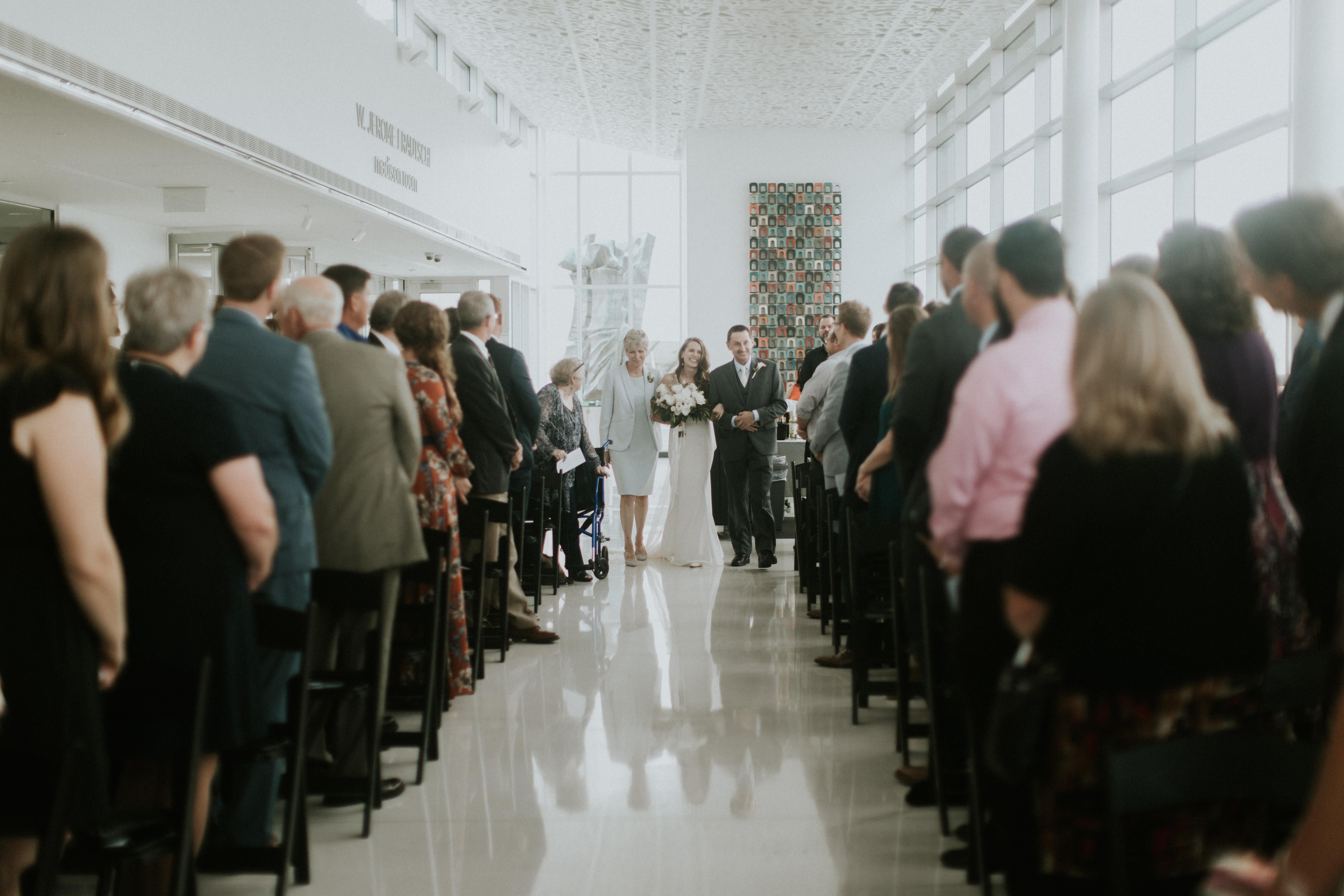 bride being walked down aisle by mother and father