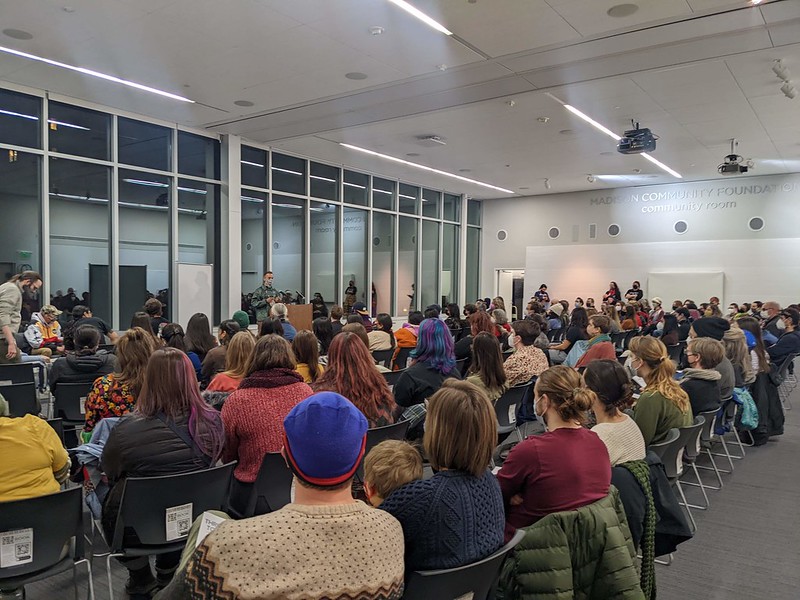 A large group of people seated and listening to a lecture 