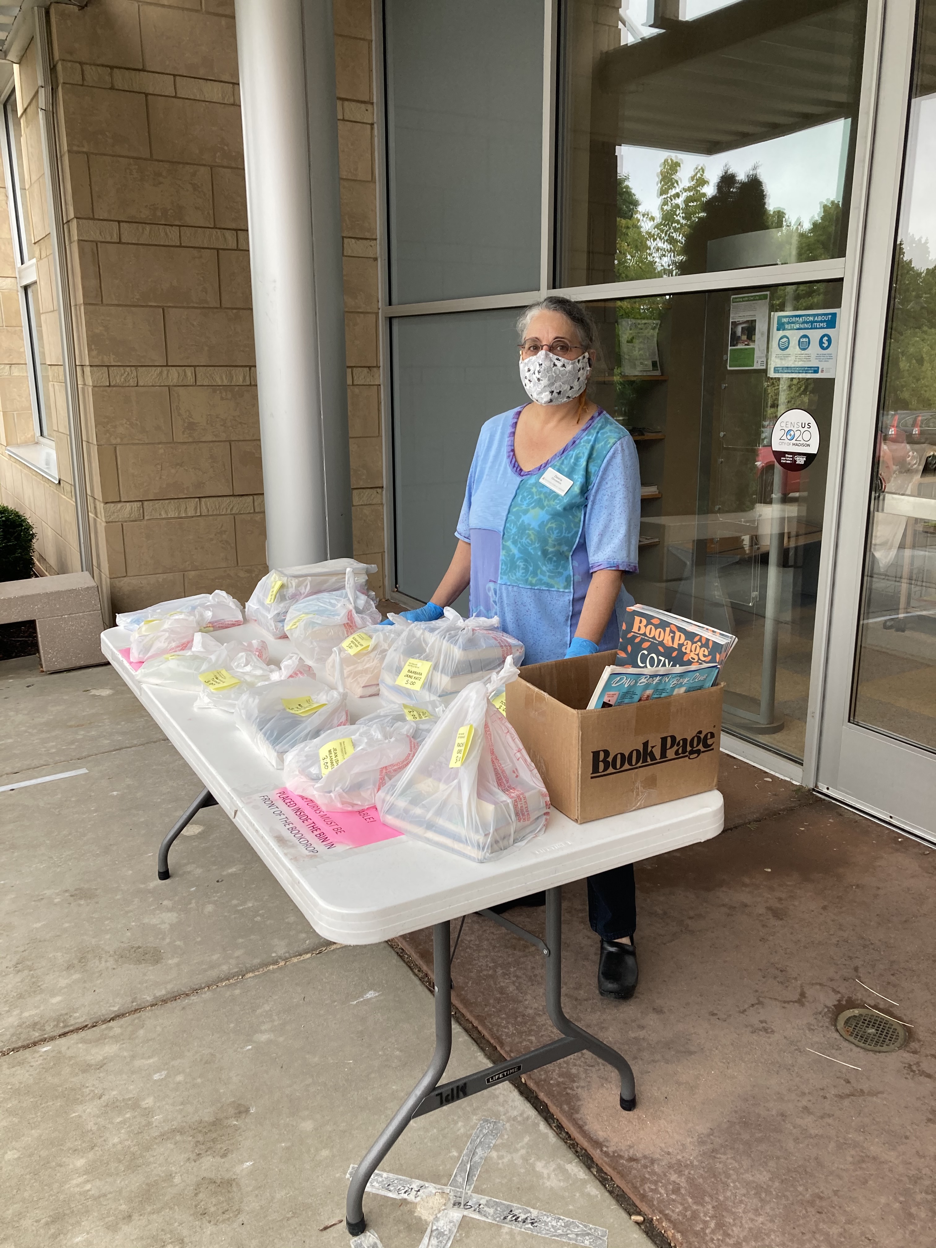 Page Deena Brazy loads the curbside table at Sequoya Library 