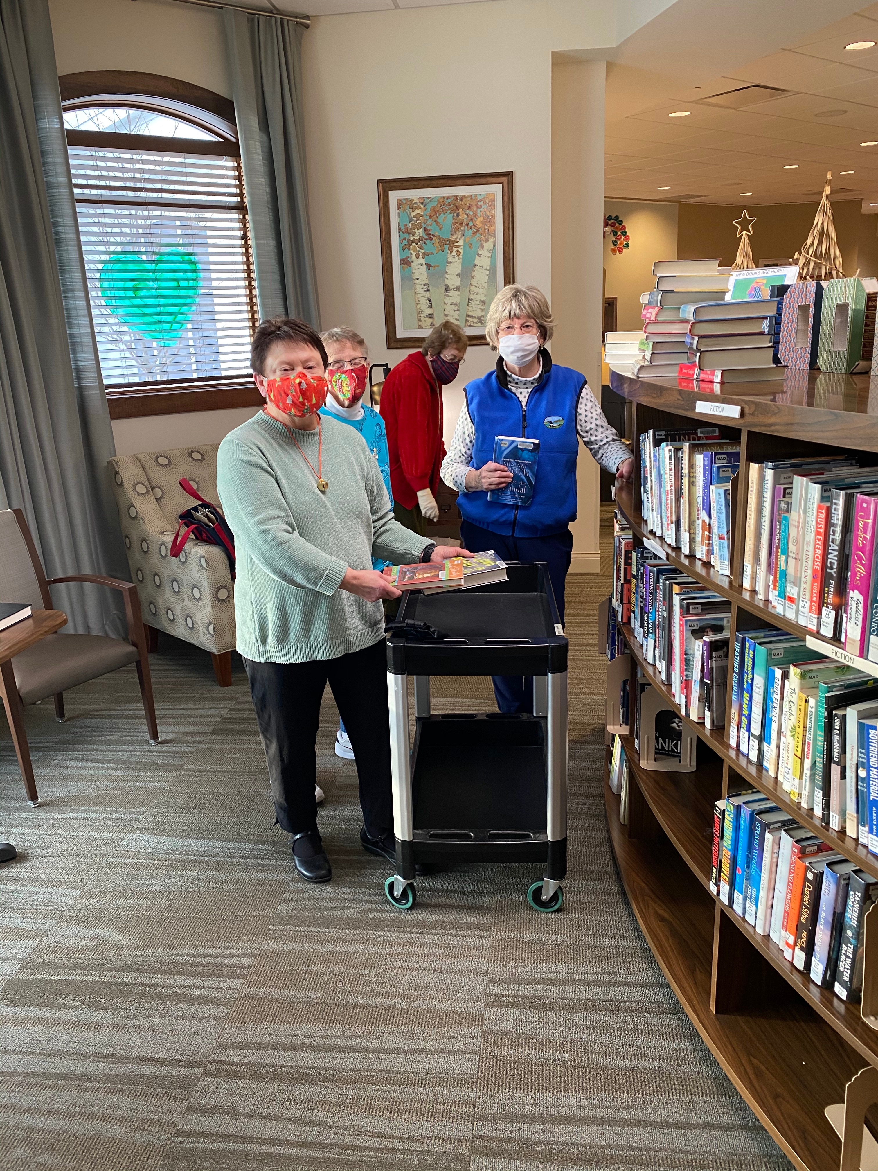 Oak Village Prairie Ridge resident volunteers stock their book nook