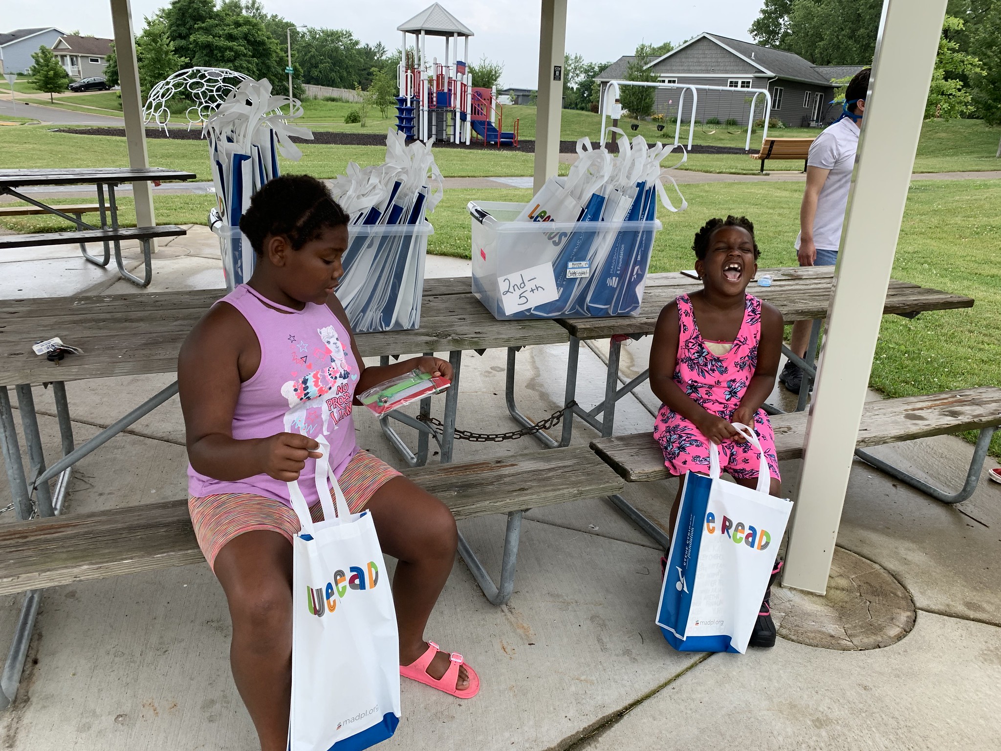 Two girls enjoy their Dream Bus books