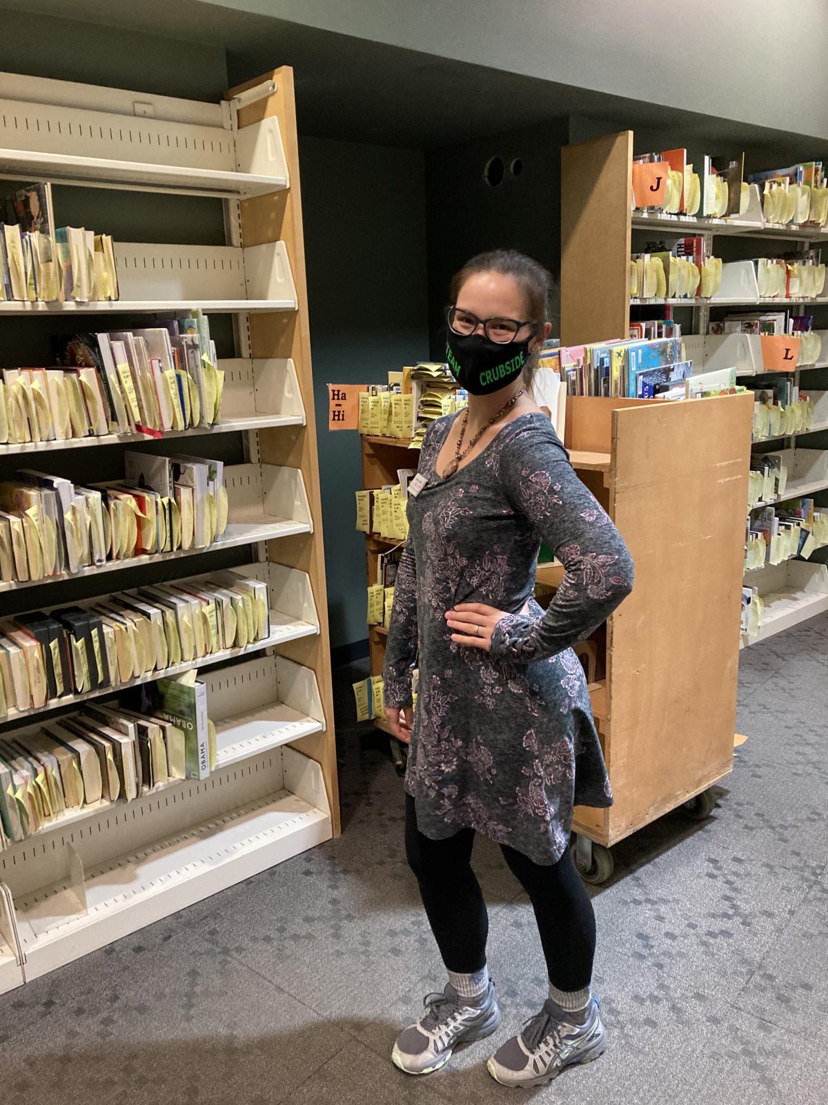 Library clerk Victoria shows off the full hold shelves at Sequoya 