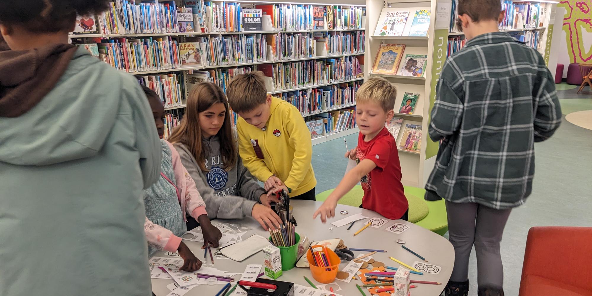 Wisconsin Book Festival Fall Celebration 2024 WE READ Youth Voices Writing Contest Author Reception Youth Voices Anthology button making