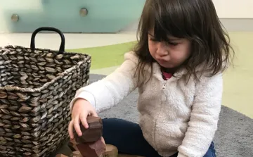 Child plays with wooden blocks