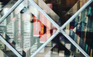 Books behind a glass door of a Little Free Library