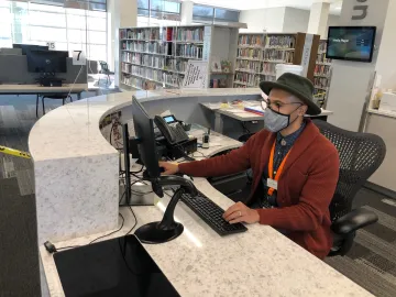 librarian Dominic Davis at the Pinney Reference Desk 