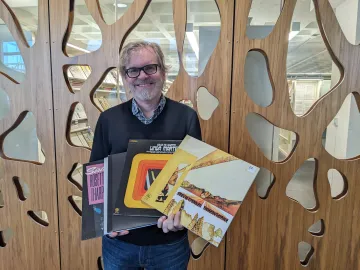 Madison Public Library's music selector Guy Hankel shows off albums at Central Library