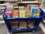 Photo of the blue cart full of children&#039;s books